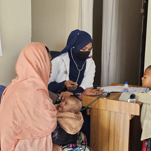 Health Assistant helping with BP